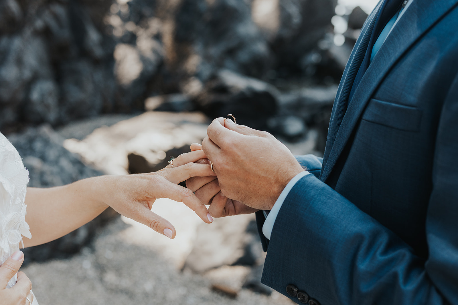 A groom holds his brides wedding ring during their ceremony at Brown's Beach in Ucluelet, BC